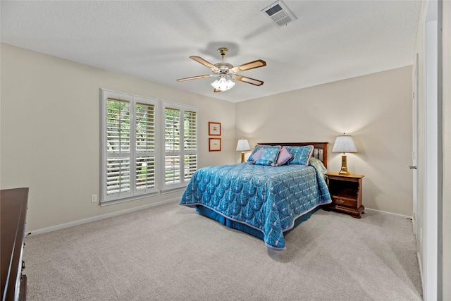 19827 Timberwind Ln, Houston, TX 77094 - bedroom with carpet floors, baseboards, ceiling fan, and a textured ceiling