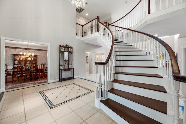 19827 Timberwind Ln, Houston, TX 77094 - foyer with a chandelier, a high ceiling, stairs, tile patterned flooring, and baseboards