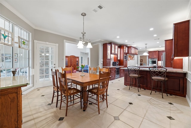 19827 Timberwind Ln, Houston, TX 77094 - dining space with crown molding, beverage cooler, light tile patterned floors, and recessed lighting