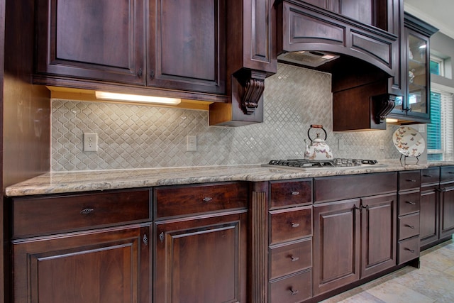 514 Chirping Sparrow Ct, Pinehurst, TX 77362 - kitchen with tasteful backsplash, glass insert cabinets, and dark brown cabinets
