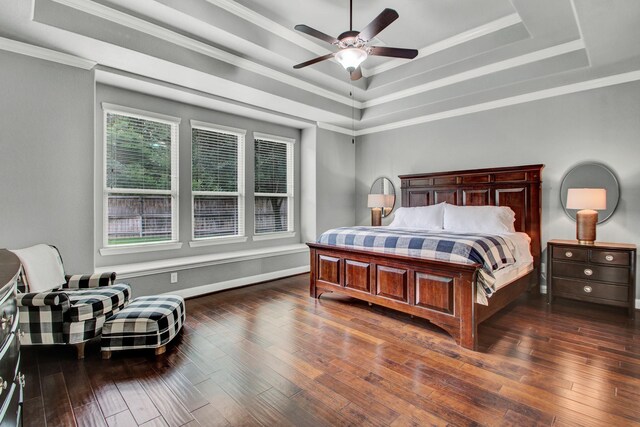 514 Chirping Sparrow Ct, Pinehurst, TX 77362 - bedroom with a raised ceiling, ornamental molding, dark wood-style flooring, and a ceiling fan