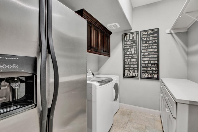 514 Chirping Sparrow Ct, Pinehurst, TX 77362 - laundry area featuring independent washer and dryer, cabinet space, baseboards, and stone tile floors