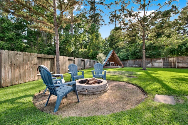514 Chirping Sparrow Ct, Pinehurst, TX 77362 - view of yard featuring an outdoor fire pit and view of wooded area