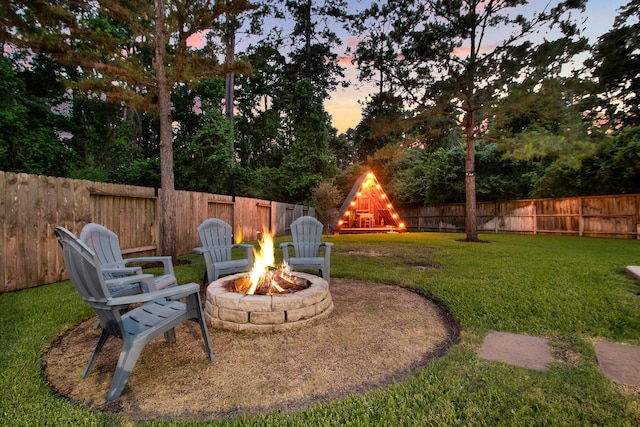 514 Chirping Sparrow Ct, Pinehurst, TX 77362 - yard at dusk with an outdoor fire pit
