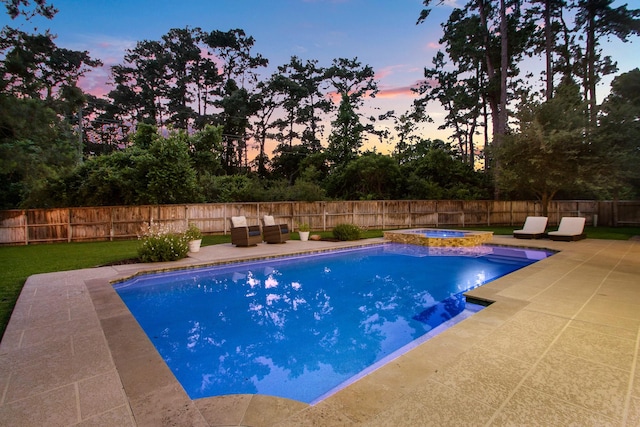 514 Chirping Sparrow Ct, Pinehurst, TX 77362 - pool at dusk featuring a patio, a fenced backyard, and a pool with connected hot tub