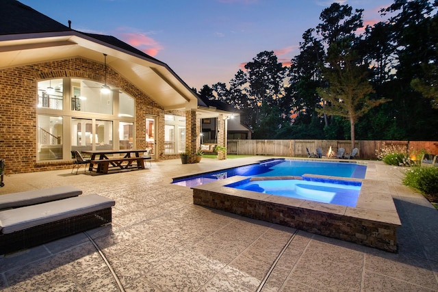 514 Chirping Sparrow Ct, Pinehurst, TX 77362 - view of swimming pool featuring a patio, a fenced backyard, an in-ground hot tub, and french doors