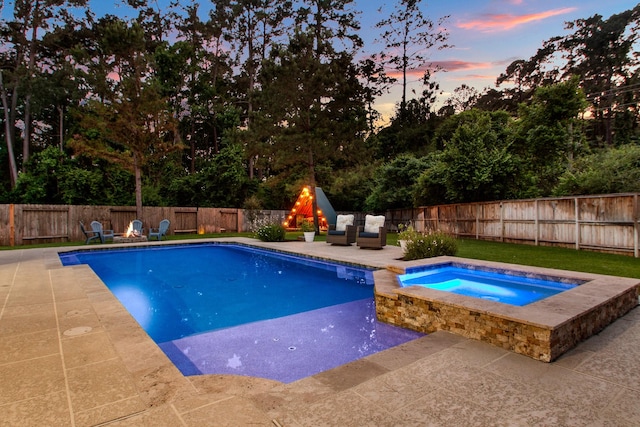 514 Chirping Sparrow Ct, Pinehurst, TX 77362 - pool at dusk with a patio area, an in-ground hot tub, and a fenced backyard