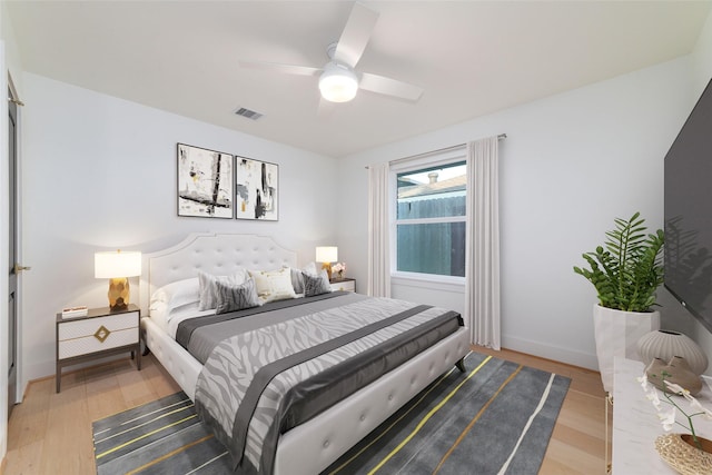 317 Kelley St, Houston, TX 77009 - bedroom with light wood-style floors, a ceiling fan, and baseboards