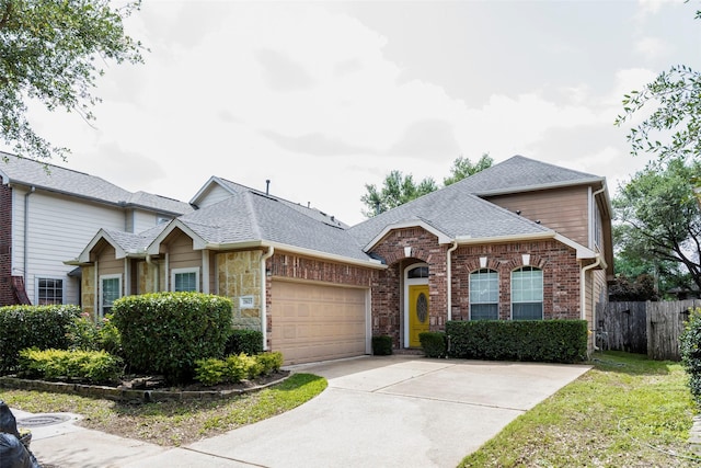 21623 Balsam Brook Ln, Katy, TX 77450 - view of front of home with an attached garage, roof with shingles, fence, concrete driveway, and brick siding