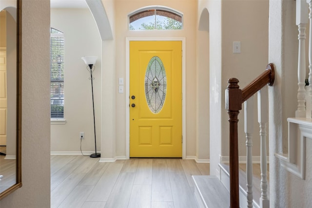 21623 Balsam Brook Ln, Katy, TX 77450 - foyer featuring light wood-type flooring, plenty of natural light, arched walkways, and baseboards