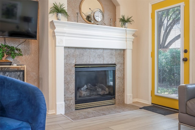 21623 Balsam Brook Ln, Katy, TX 77450 - detailed view of wood finished floors, a tiled fireplace, and baseboards