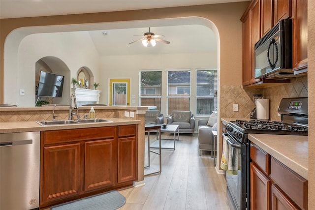 21623 Balsam Brook Ln, Katy, TX 77450 - kitchen with black appliances, a sink, ceiling fan, open floor plan, and lofted ceiling