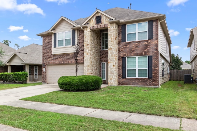 30722 Lavender Trace Dr, Spring, TX 77386 - view of front of home featuring central AC, a garage, driveway, brick siding, and stone siding