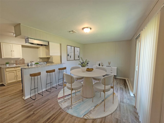 dining area featuring wood finished floors and baseboards