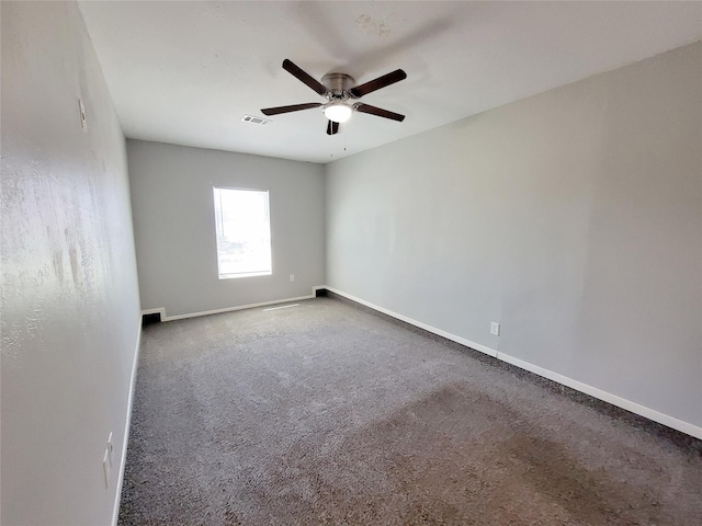 spare room featuring ceiling fan, carpet flooring, and baseboards