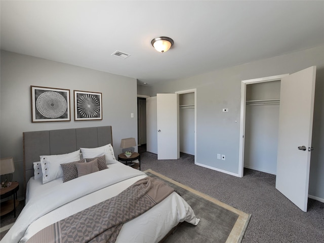 bedroom with two closets, carpet flooring, and baseboards
