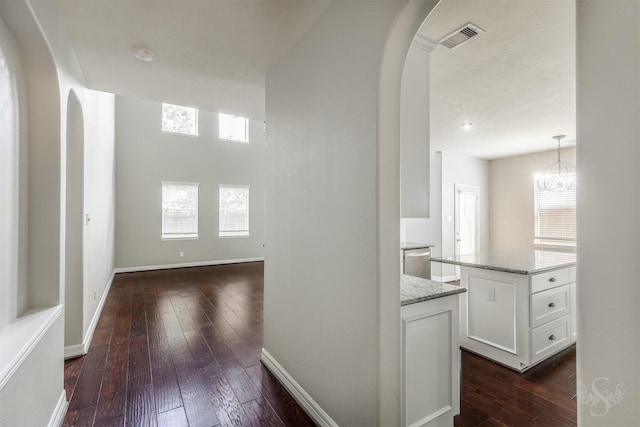 3722 Rocky Ledge Ln, Katy, TX 77494 - hallway featuring arched walkways, plenty of natural light, and dark wood-style flooring