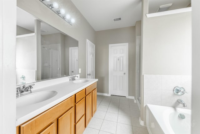 3722 Rocky Ledge Ln, Katy, TX 77494 - full bathroom with tile patterned flooring, double vanity, a garden tub, a stall shower, and baseboards