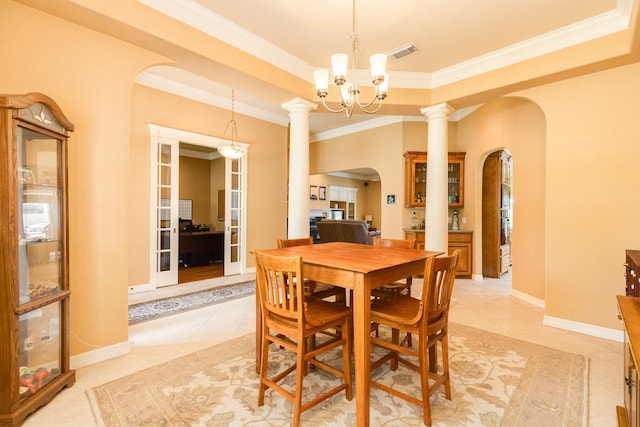 54 Scotch Pine Ct, Lake Jackson, TX 77566 - dining area with arched walkways, light tile patterned floors, crown molding, decorative columns, and a chandelier