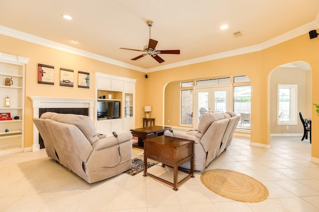 54 Scotch Pine Ct, Lake Jackson, TX 77566 - living room featuring arched walkways, crown molding, light tile patterned flooring, ceiling fan, and built in shelves