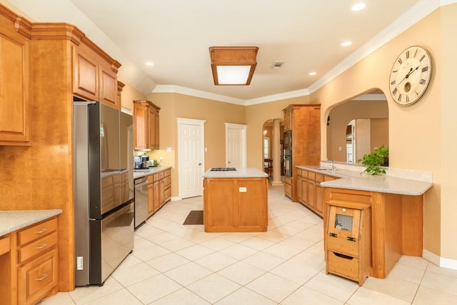 54 Scotch Pine Ct, Lake Jackson, TX 77566 - kitchen featuring stainless steel appliances, arched walkways, a kitchen island, light tile patterned floors, and a sink
