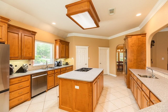 54 Scotch Pine Ct, Lake Jackson, TX 77566 - kitchen featuring stainless steel appliances, a sink, arched walkways, a kitchen island, and ornamental molding