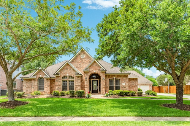 54 Scotch Pine Ct, Lake Jackson, TX 77566 - view of front of house with brick siding, a garage, and roof with shingles