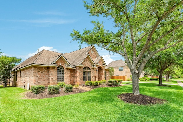 54 Scotch Pine Ct, Lake Jackson, TX 77566 - view of front facade with brick siding, a front lawn, and roof with shingles
