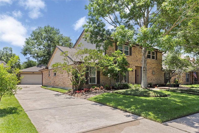 view of front facade featuring brick siding, a front lawn, driveway, and a garage
