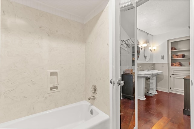 bathroom with wood finished floors, shower / tub combination, and baseboards