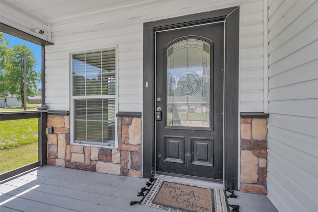 1107 Cypress St, Diboll, TX 75941 - view of exterior entry with a porch and stone siding