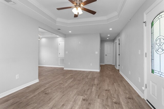 1107 Cypress St, Diboll, TX 75941 - unfurnished room with recessed lighting, a ceiling fan, plenty of natural light, a raised ceiling, and wood finished floors
