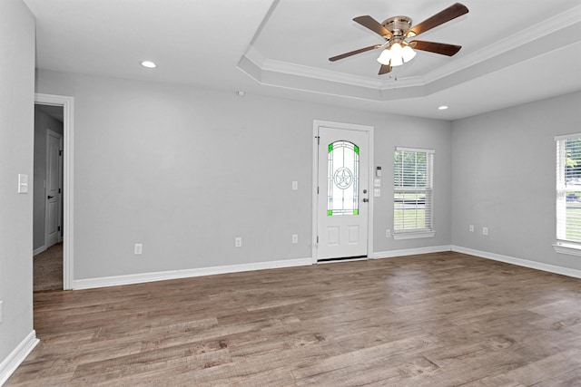 1107 Cypress St, Diboll, TX 75941 - foyer with a tray ceiling, crown molding, wood finished floors, a ceiling fan, and baseboards
