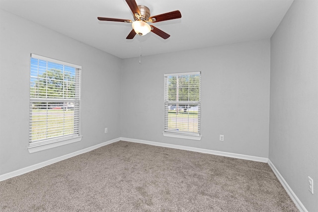 1107 Cypress St, Diboll, TX 75941 - unfurnished room featuring carpet, plenty of natural light, ceiling fan, and baseboards