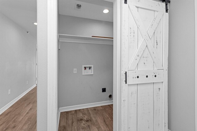 1107 Cypress St, Diboll, TX 75941 - washroom featuring wood finished floors, baseboards, and a barn door