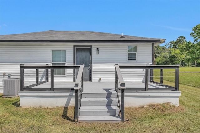 1107 Cypress St, Diboll, TX 75941 - rear view of property with central AC, a yard, a deck, and roof with shingles