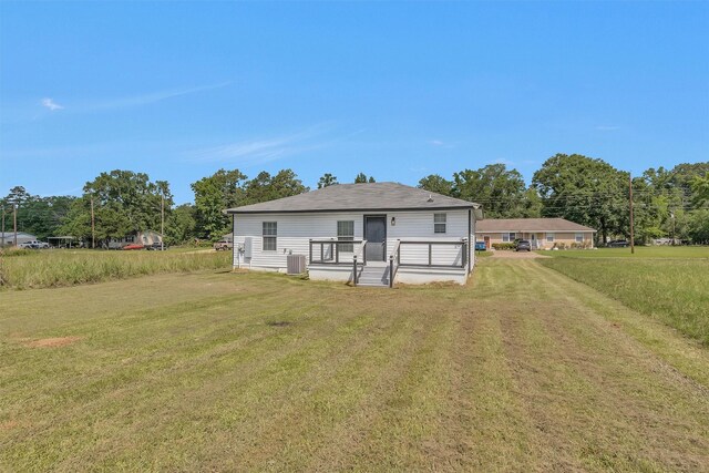 1107 Cypress St, Diboll, TX 75941 - rear view of house featuring a lawn and cooling unit