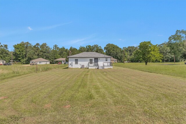 1107 Cypress St, Diboll, TX 75941 - rear view of house with a yard
