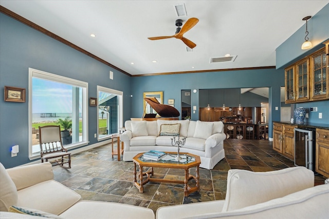3814 Todville Rd, Seabrook, TX 77586 - living room with beverage cooler, stone tile flooring, a dry bar, ornamental molding, and a ceiling fan