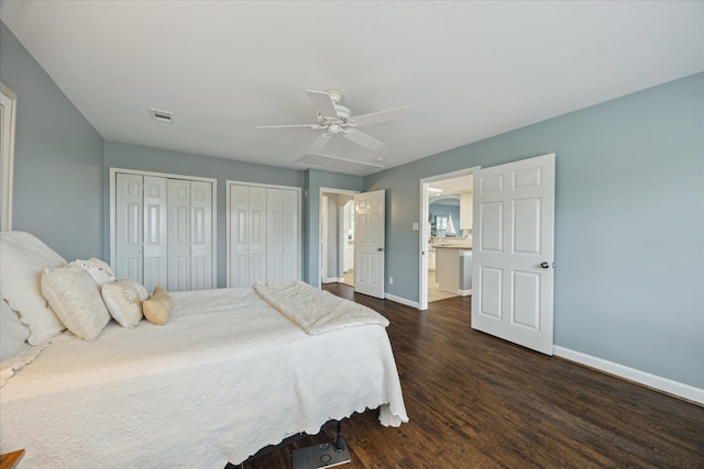 3814 Todville Rd, Seabrook, TX 77586 - bedroom featuring baseboards, two closets, dark wood-type flooring, and ceiling fan
