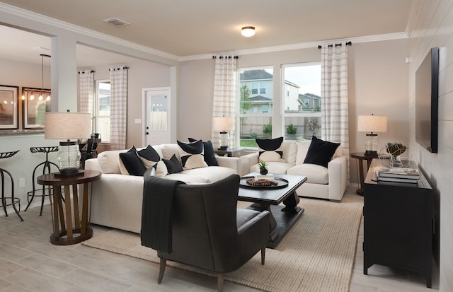 living room with healthy amount of natural light and crown molding