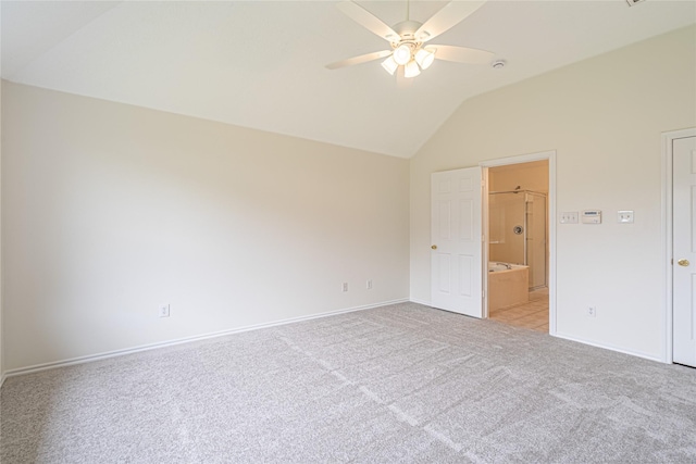 unfurnished bedroom with vaulted ceiling, light carpet, baseboards, ensuite bathroom, and a ceiling fan