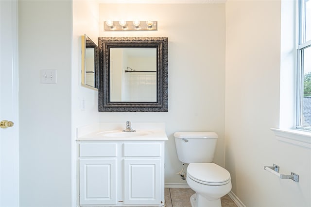 bathroom featuring toilet, baseboards, vanity, and tile patterned flooring