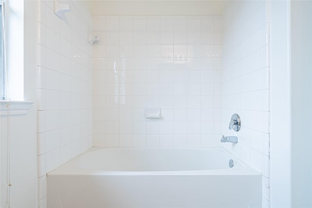 bathroom featuring a tub and a shower