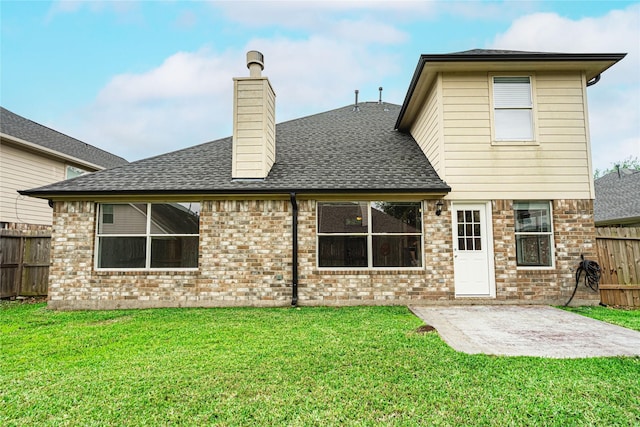 rear view of house with a patio area, brick siding, a shingled roof, and a chimney