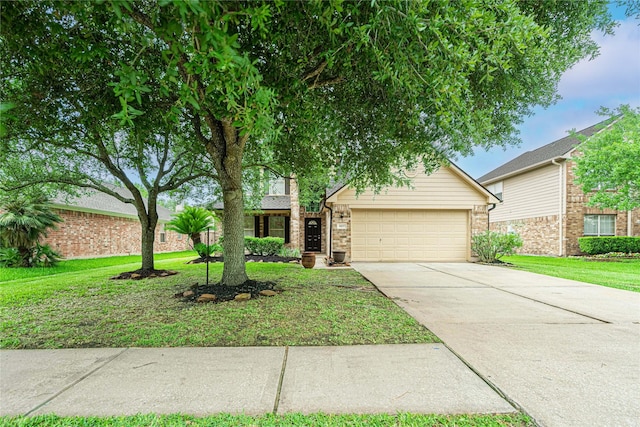 view of front of property featuring an attached garage, driveway, a front lawn, and brick siding