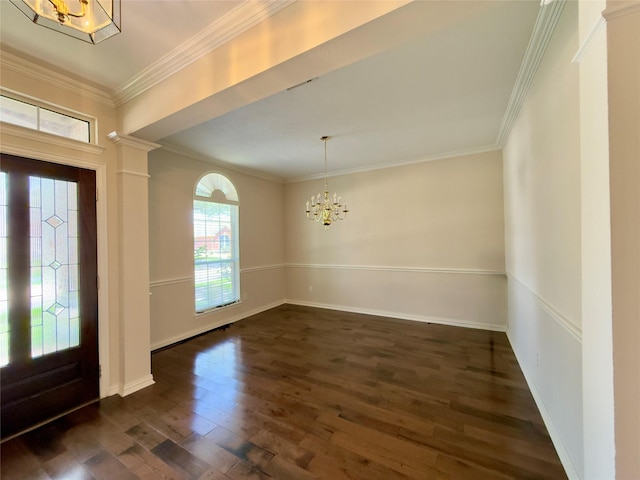 foyer with a chandelier, dark wood-style floors, crown molding, and baseboards