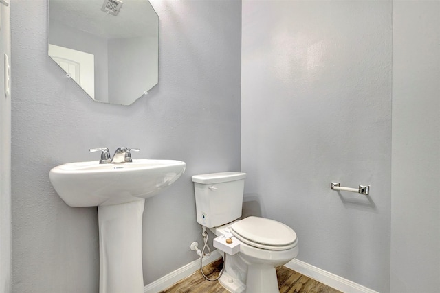 3807 Springcrest Ln, Montgomery, TX 77356 - bathroom with wood finished floors, toilet, baseboards, and a sink