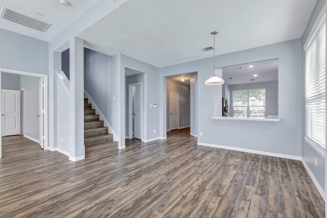 3807 Springcrest Ln, Montgomery, TX 77356 - unfurnished living room with dark wood-style floors, stairs, and baseboards