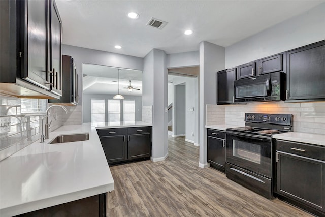 3807 Springcrest Ln, Montgomery, TX 77356 - kitchen with black appliances, a sink, light countertops, baseboards, and recessed lighting